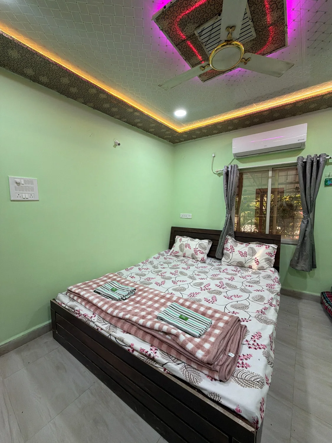 AC bedroom with double bed and ceiling lights